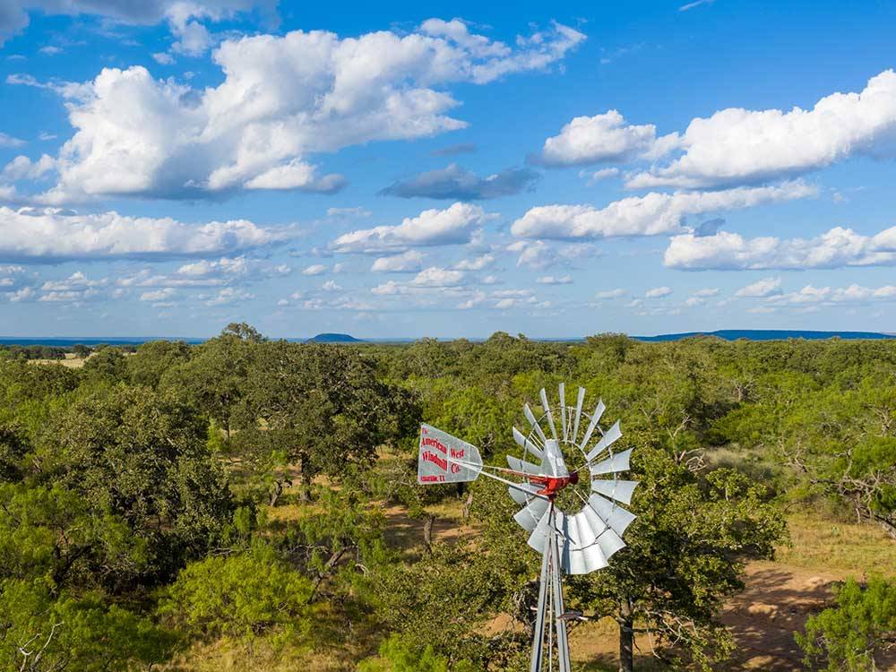 A windmill next to a lot of trees at SKYE TEXAS HILL COUNTRY RESORT