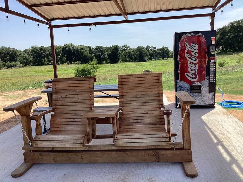 A wooden two seater rocker at OLD TOWNE RV RANCH