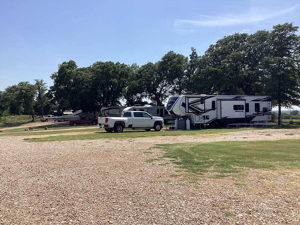 White truck and fifth wheel in a gravel site at OLD TOWNE RV RANCH