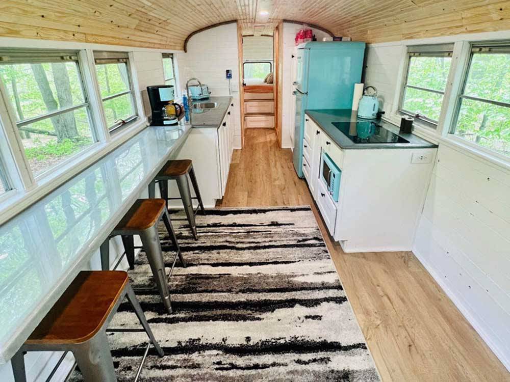 The inside of the bus conversion at DANCING FIRE GLAMPING AND RV RESORT