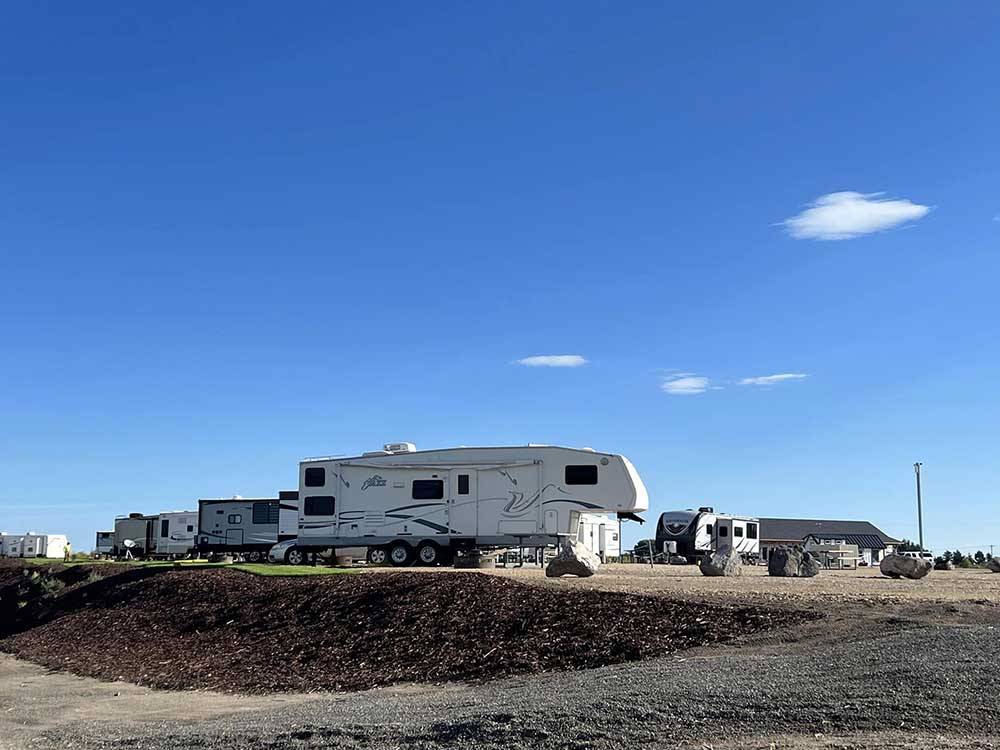 Travel trailers parked in gravel sites at LUCKY LAKE 208