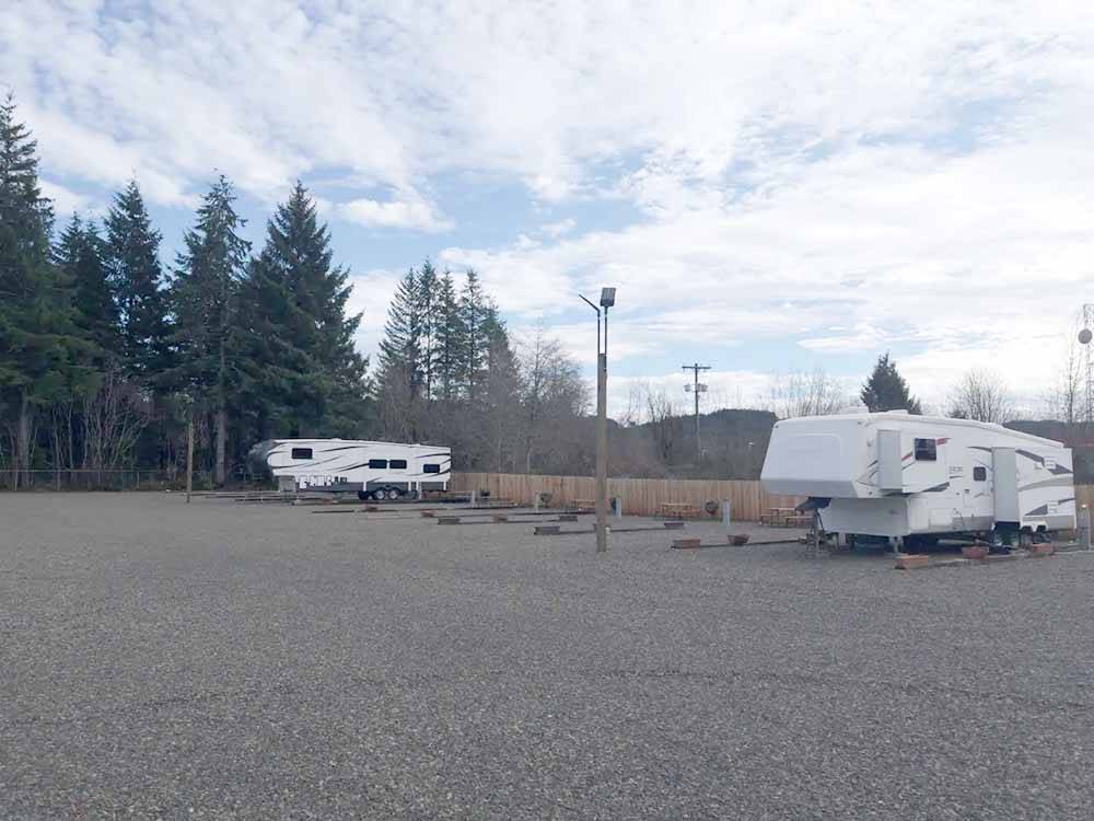 A gravel area leading to RV spots at FAR WEST RV PARK