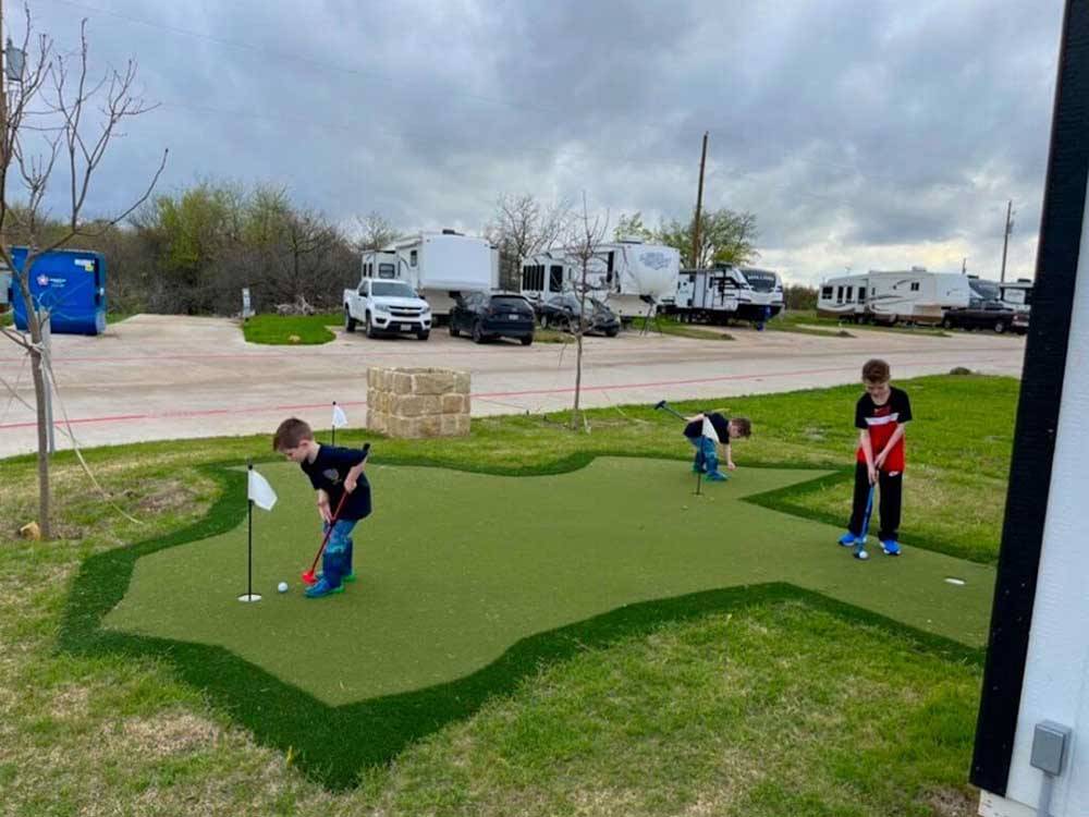 Kids playing on the mini golf course at THE RV RESORT