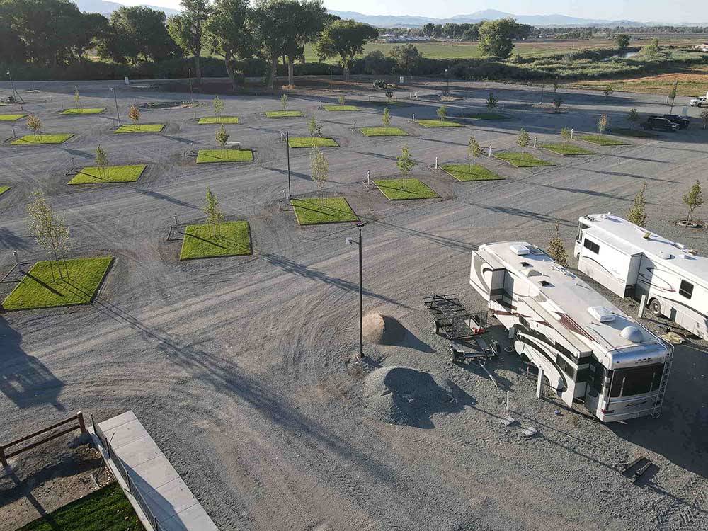 Aerial view of empty gravel RV sites at WHISPERING RIVER RANCH RV PARK