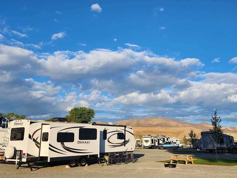Trailers parked in gravel sites at WHISPERING RIVER RANCH RV PARK