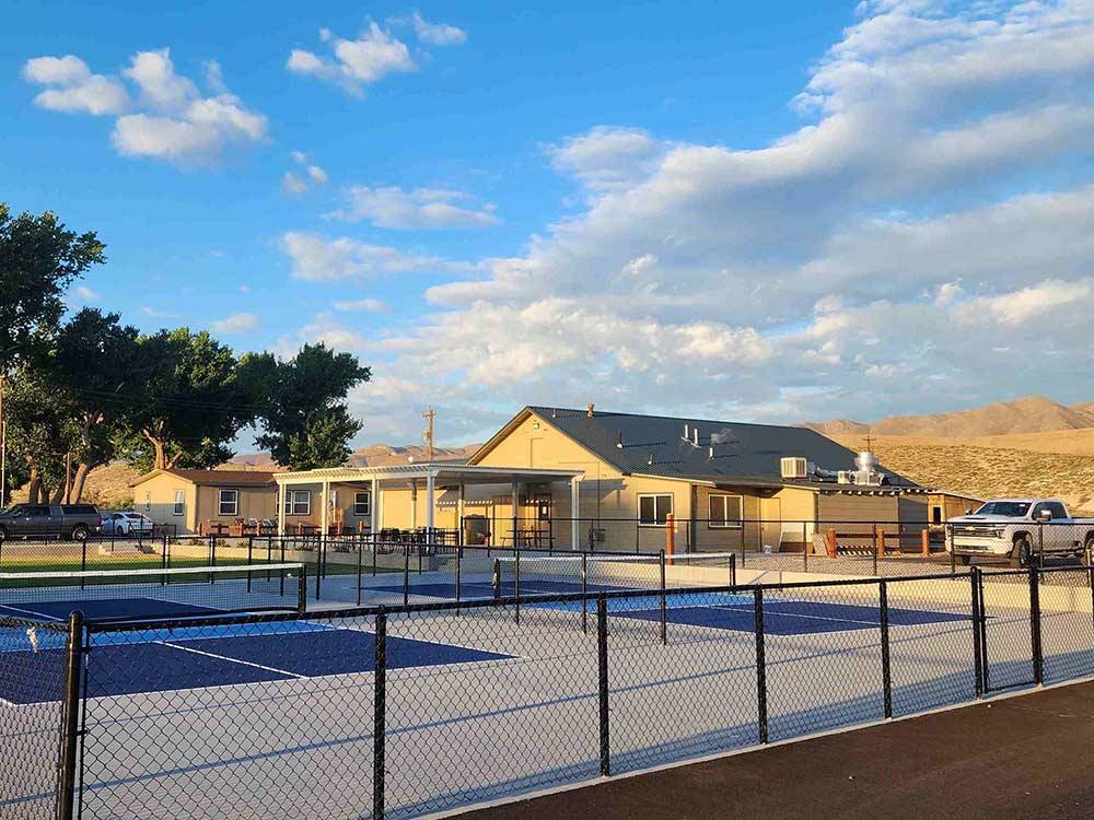 The pickle balls courts next to the clubhouse at WHISPERING RIVER RANCH RV PARK