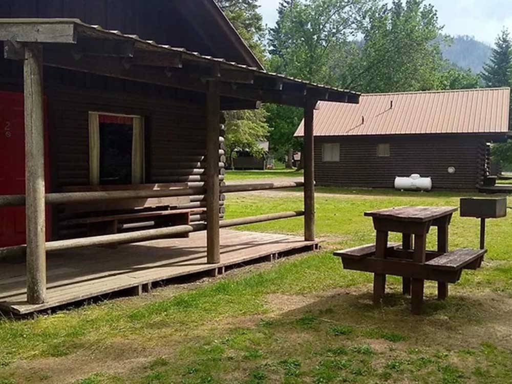 Two cabin rentals with benches at THREE RIVERS RESORT