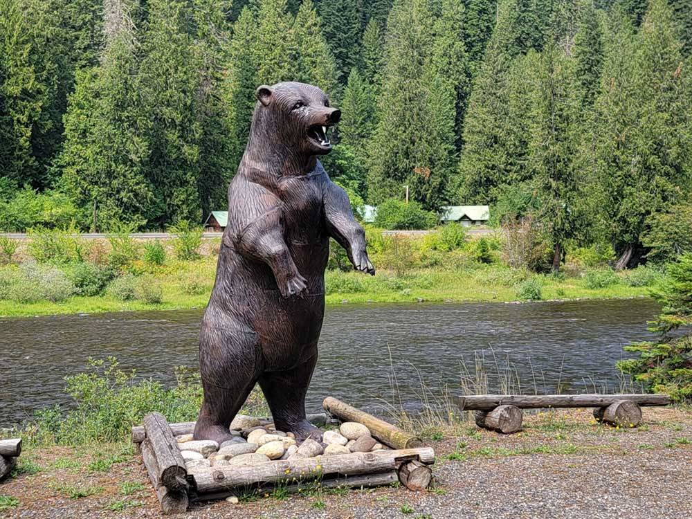 A large bear statue by the river at THREE RIVERS RESORT