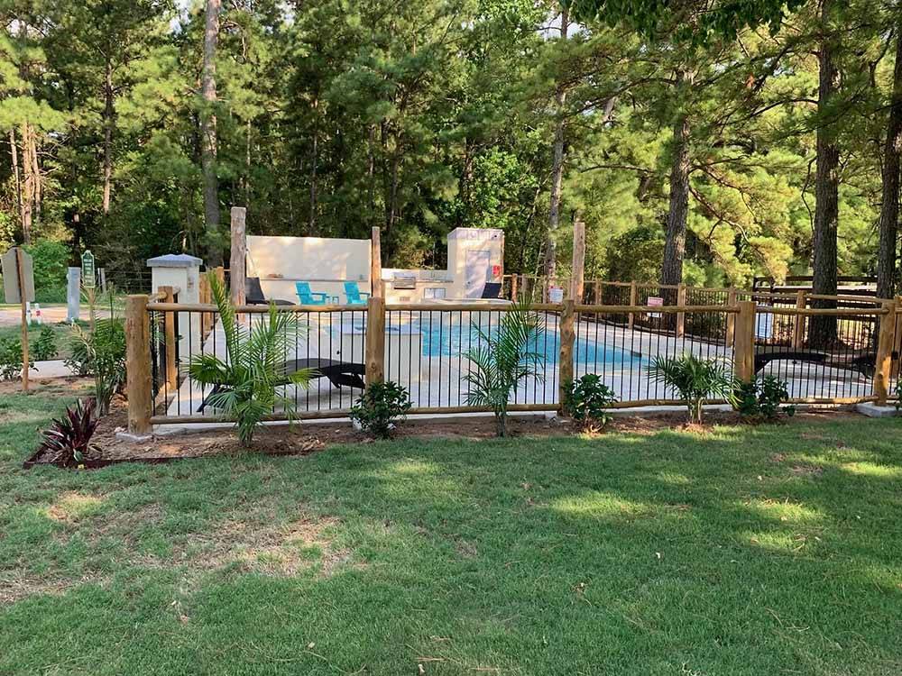 The fenced-in swimming pool at HIDDEN LAKE RV RESORT