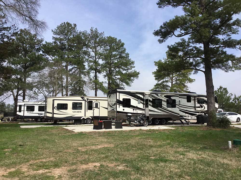 A row of trailers parked in RV sites at HIDDEN LAKE RV RESORT