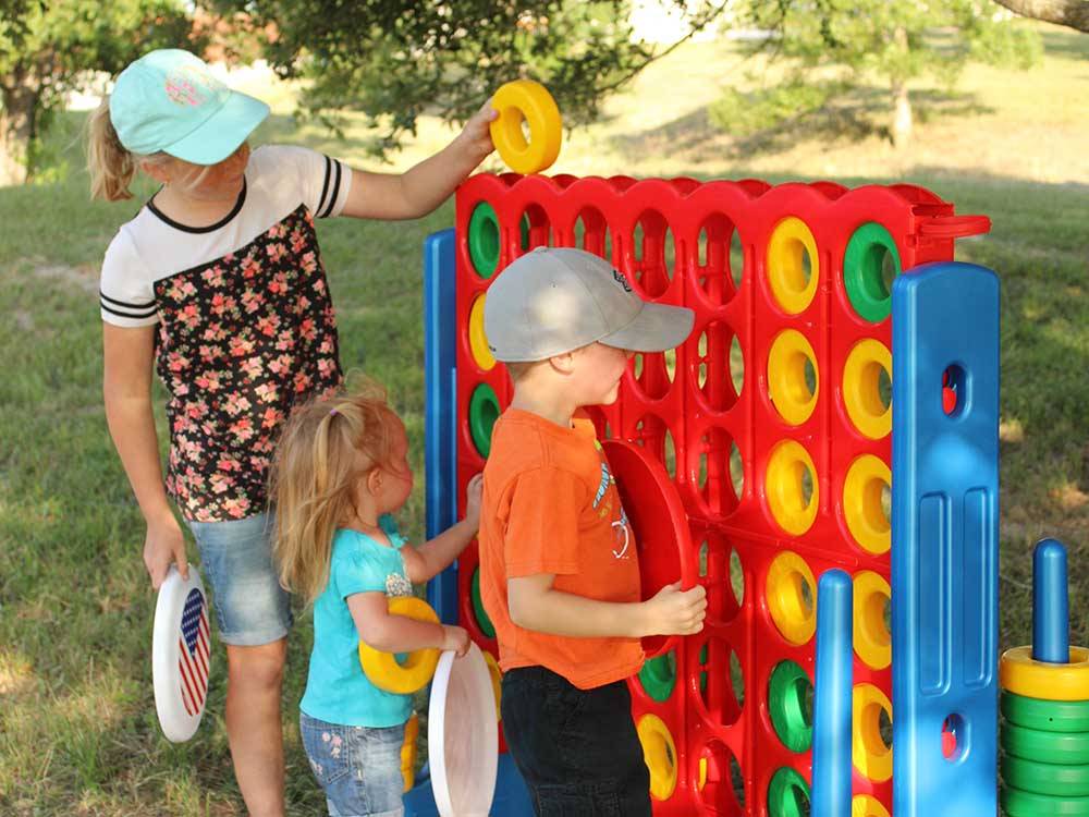 Kids playing the giant Connect 4 game at LAKE DEWBERRY RV RESORT