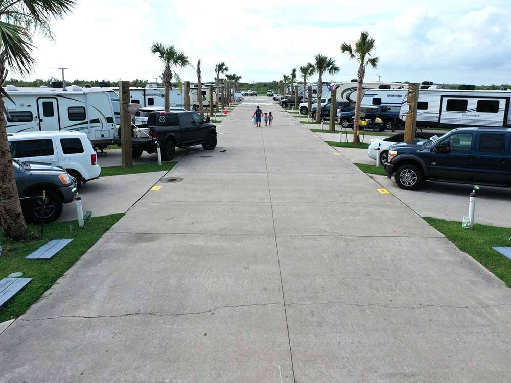 Rows of RVs parked in paved sites at THE PALAPA RV BEACH RESORT