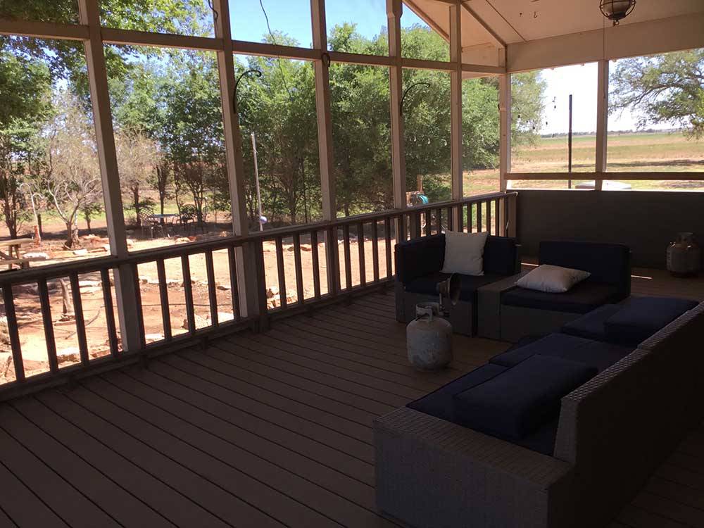 The couches on the deck with a propane heat at SHEPHERD FAMILY CABINS & RV CAMPGROUND