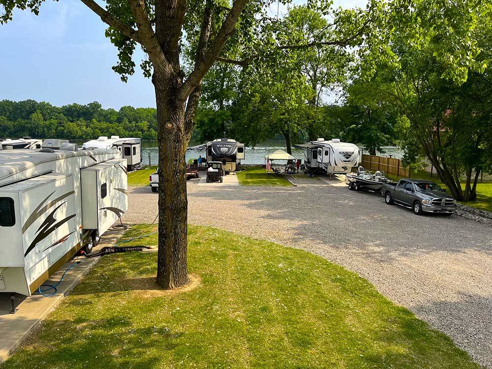 A row of trailers parked by the river at BOTEL CAMPGROUND