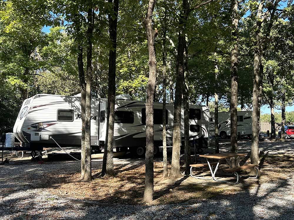 A travel trailer parked in a RV site at RUSTIC RIDGE