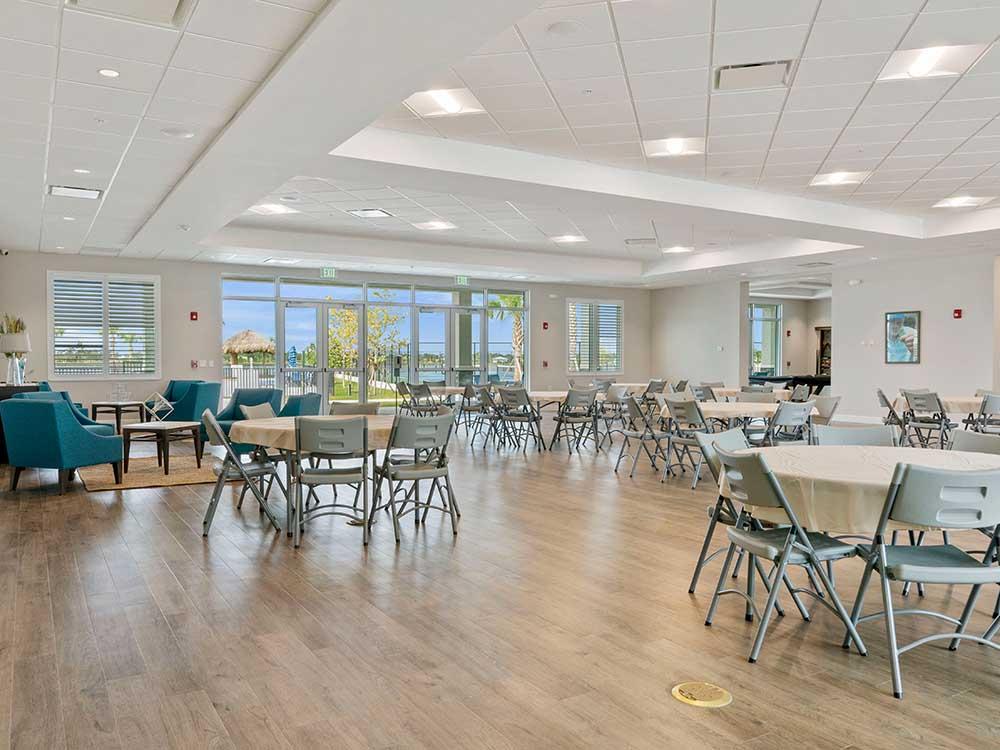 Chairs and tables inside the community room at ENCORE TRANQUILITY LAKES
