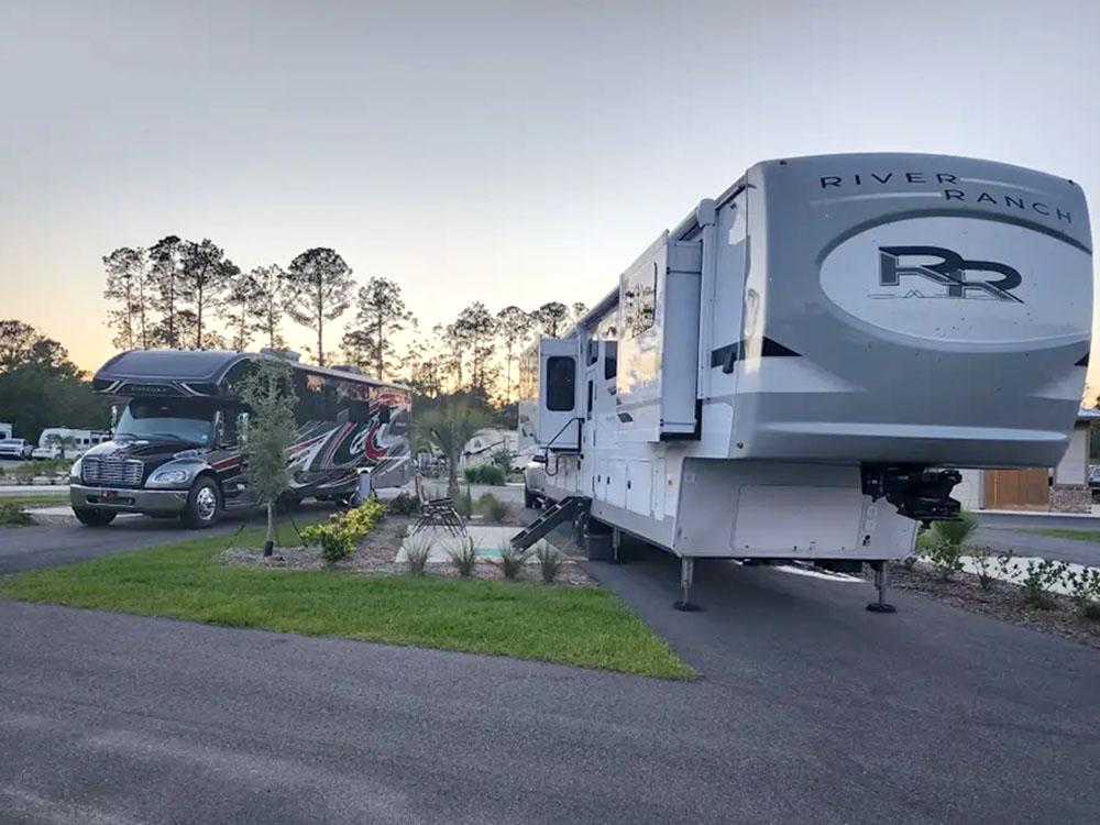 A fifth wheel parked in a paved site at SANTA FE PALMS RV RESORT