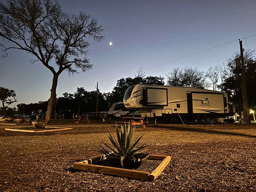 Trailers parked in sites at night at STARRY NIGHT RV RESORT