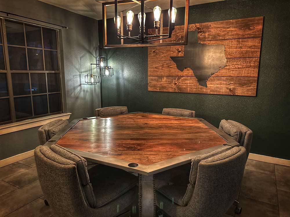 A poker table in a room with a picture of Texas on the wall at STARRY NIGHT RV RESORT