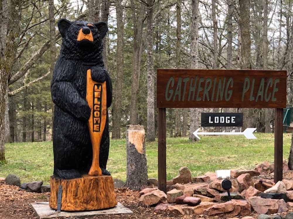 A bear statue next to the park sign at GATHERING PLACE RESORT & LODGE