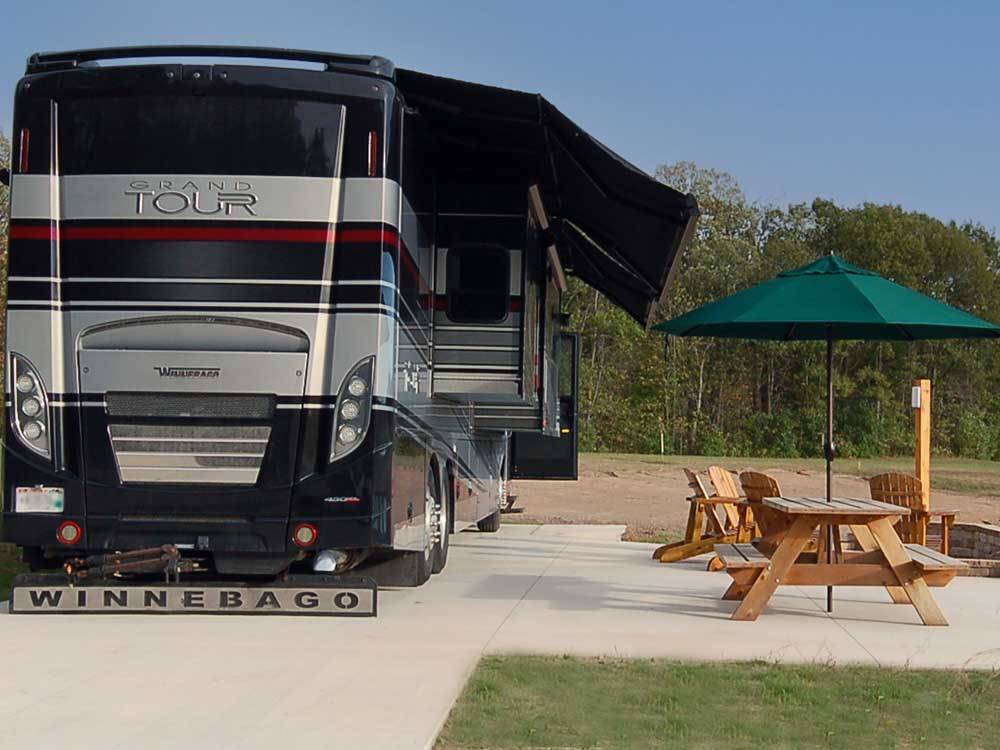 A motorhome in a paved site at GATHERING PLACE RESORT & LODGE