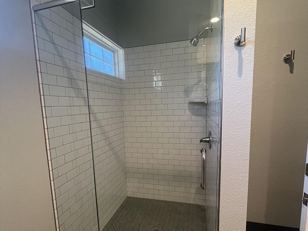 Interior of a nice tiled shower at STARRVILLE RV RESORT