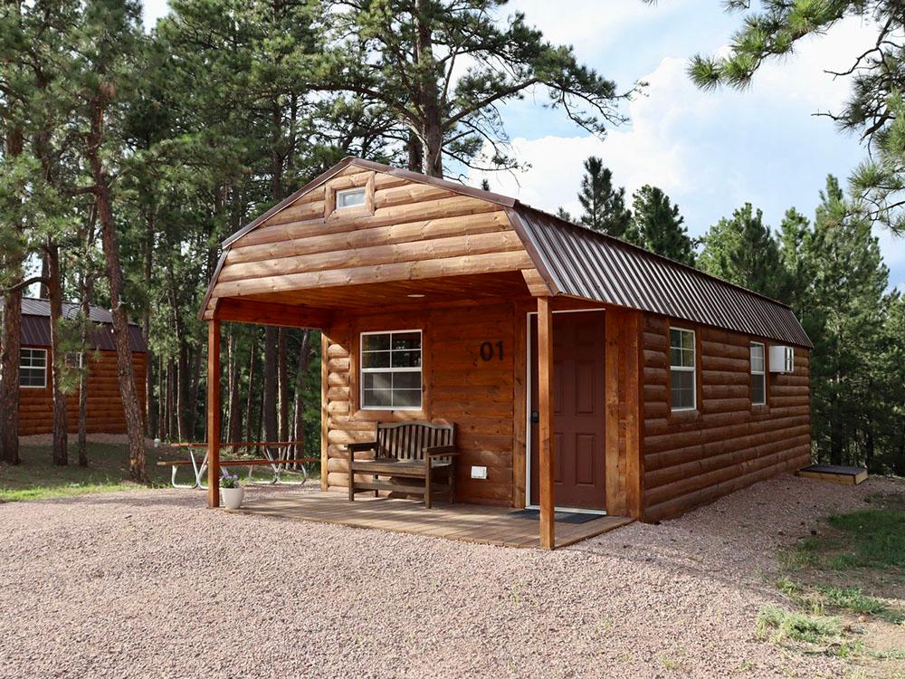 Exterior of a log rental cabin at PINE HAVEN VENUE & LODGING