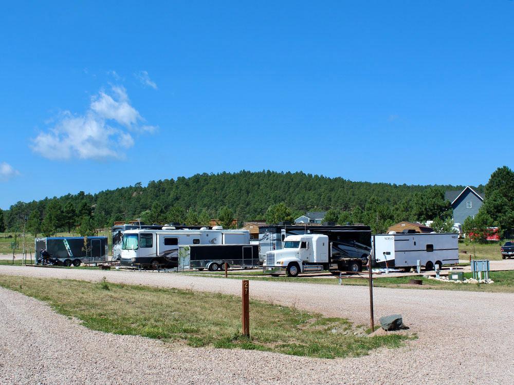 A big rig and other RVs at site at PINE HAVEN VENUE & LODGING