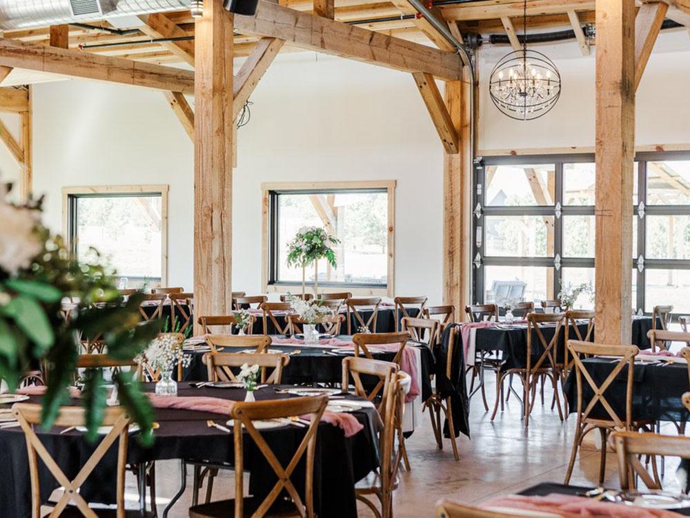 Tables set for a dining event at PINE HAVEN VENUE & LODGING