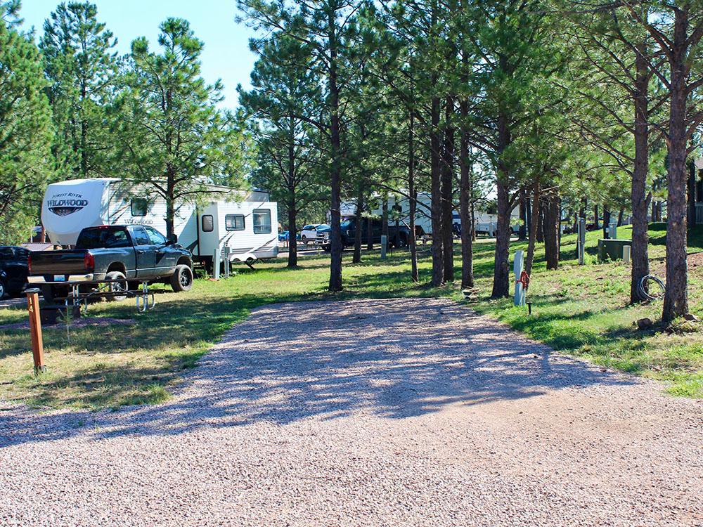 A gravel RV site at PINE HAVEN VENUE & LODGING