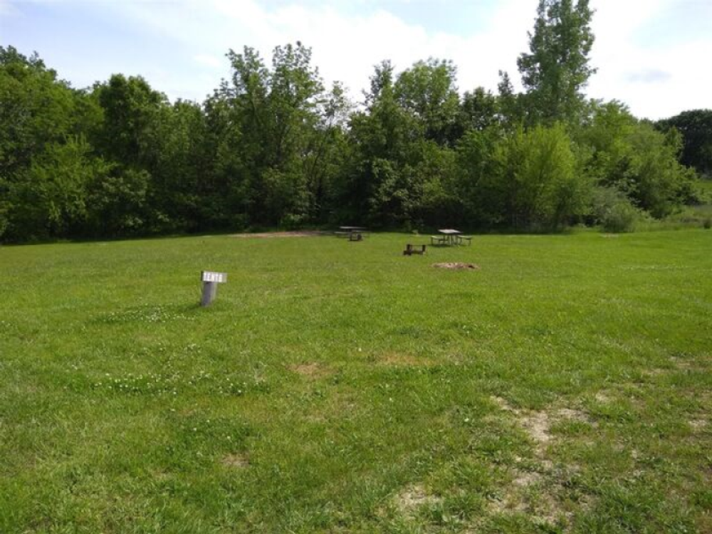 Grass site with picnic table at Powell's Creekside Haven