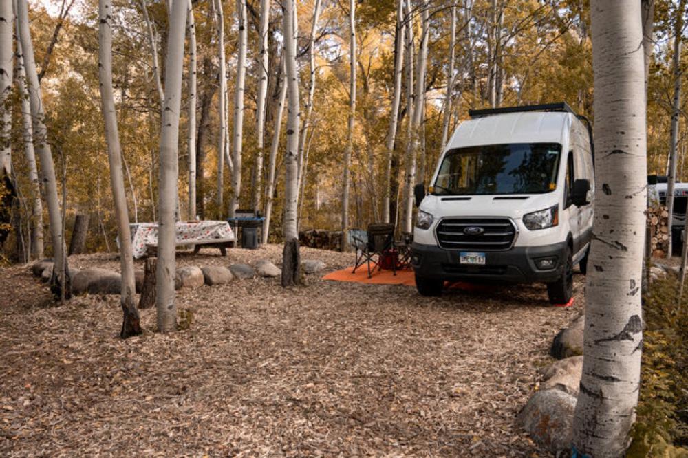 Van in a mulch covered site at Creekside Chalets