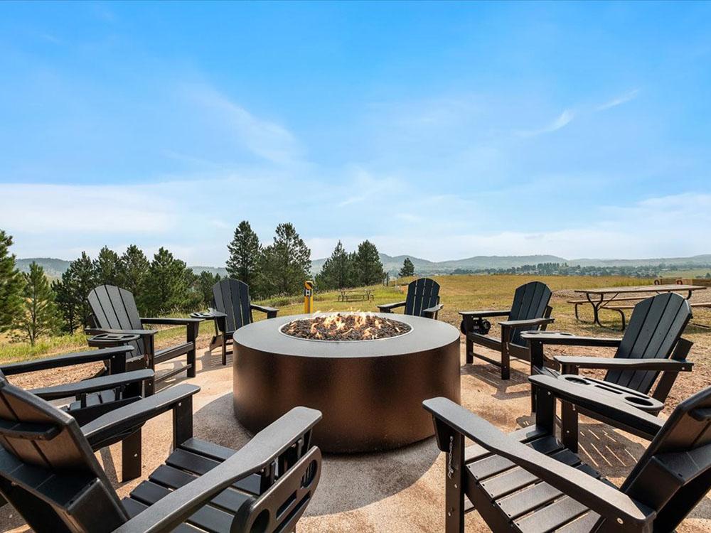 Adirondack chair seating around a fire pit at BLACK HILLS VISTA RV PARK