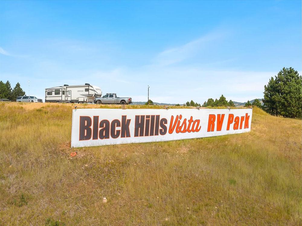 The park sign in a grassy area at BLACK HILLS VISTA RV PARK