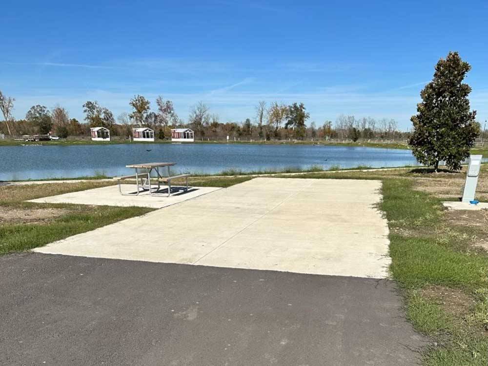 A concrete RV site with a picnic bench at TIGER'S TRAIL RV RESORT