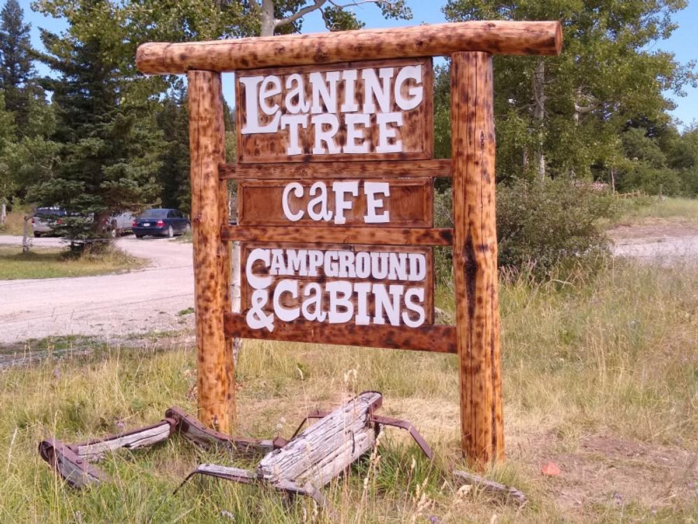 Rustic park sign at Leaning Tree Cafe and Campground