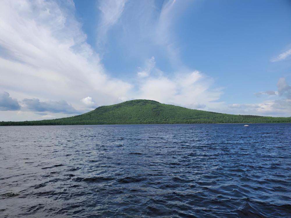 Lake with mountain in the background at Jackman Landing Campground & Cabins