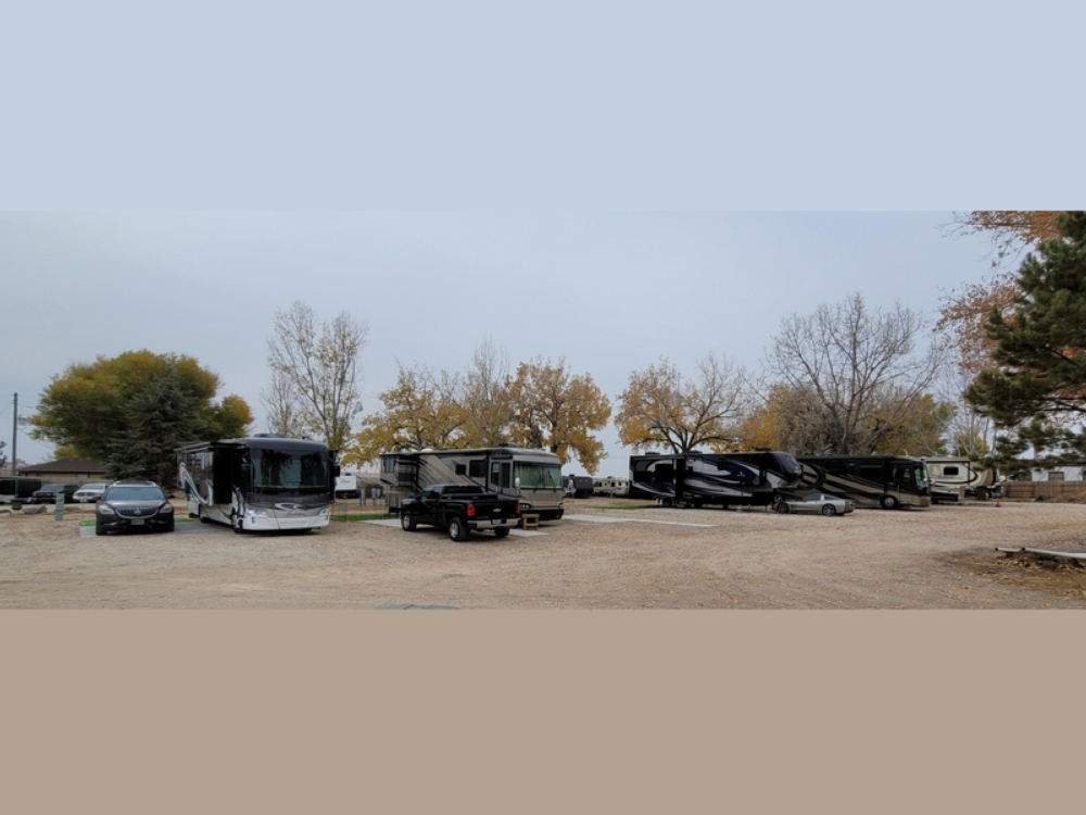 RVs lined up in gravel sites at Falcon's Landing RV Park