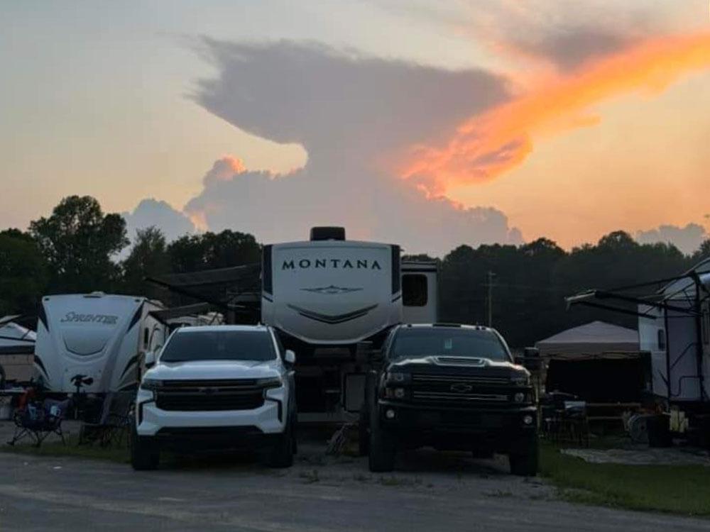 RVs parked in sites at sunset at THE LANDING STRIP CAMPGROUND