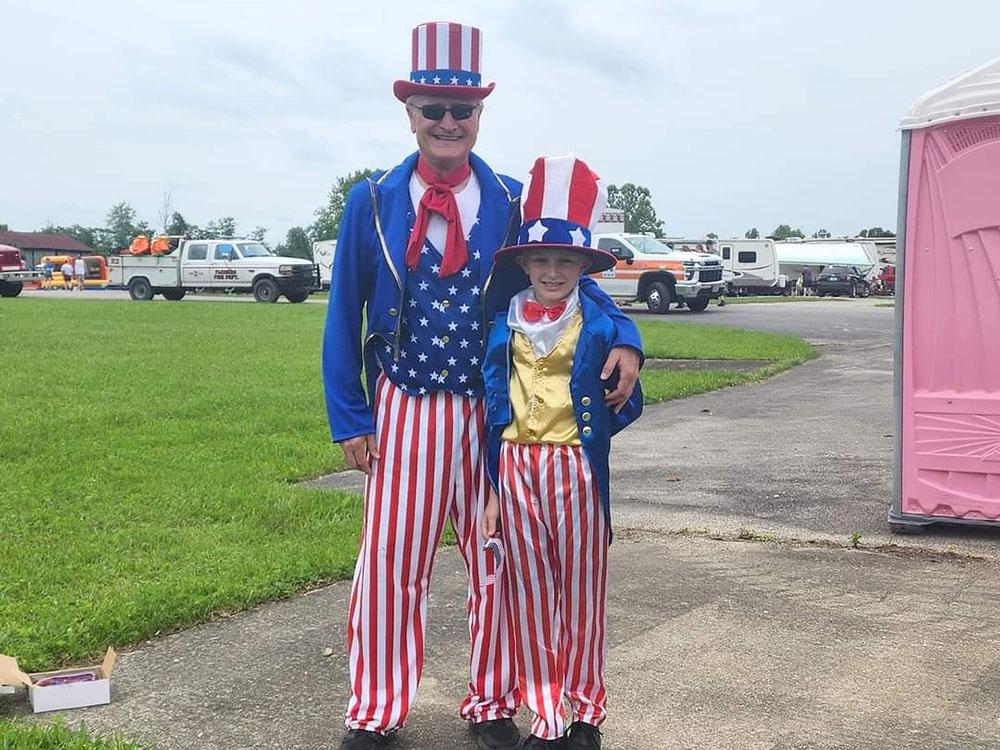 A man and a boy dressed for Fourth of July at THE LANDING STRIP CAMPGROUND