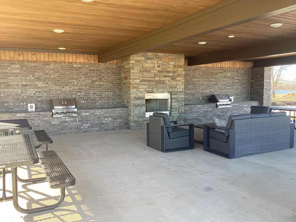 A sitting area with bbq pits at RIVERFRONT RV RESORT