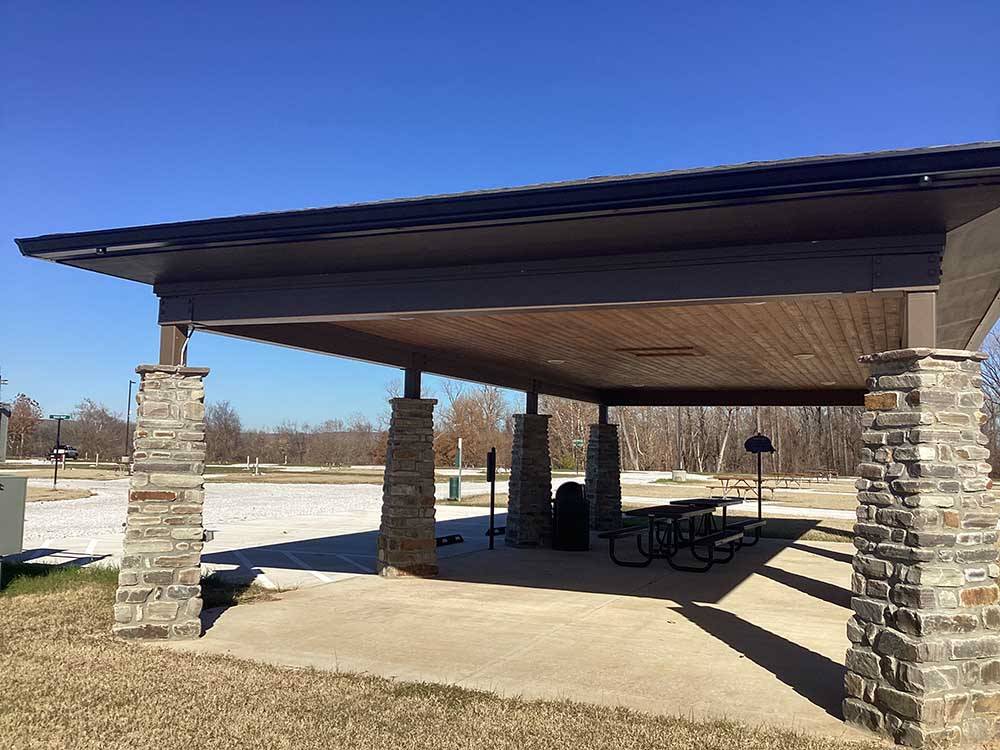 Picnic benches under a pavilion at RIVERFRONT RV RESORT