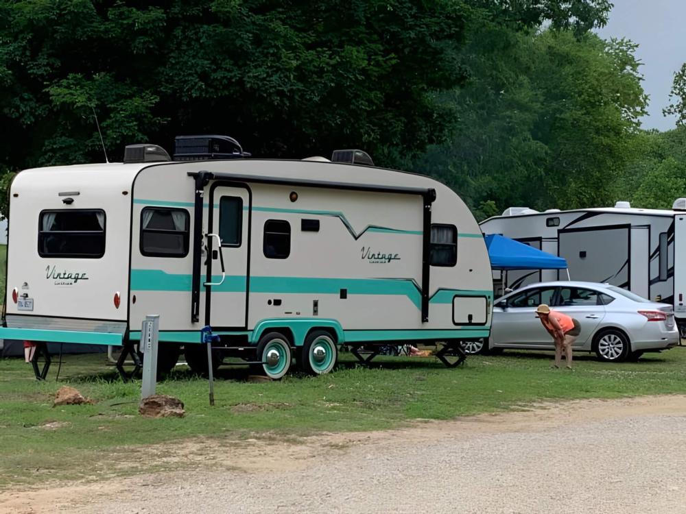 Parked travel trailer at site Broken Arrow Campground