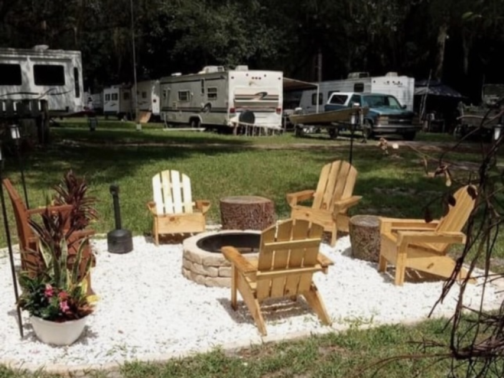 Adirondack chairs around a fire pit at St John's Campground