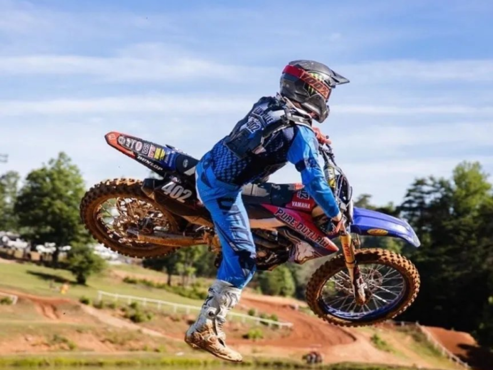 Person riding a dirt bike at Lake Sugar Tree