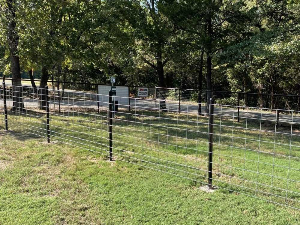 The fenced-in pet area at GONE FISHING RV RESORT