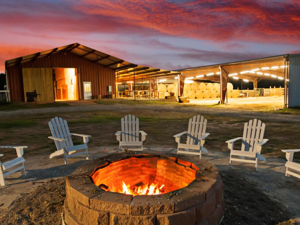 Chairs arranged around a fire pit at sunset at Cora's Cabins (Savannahs Events)