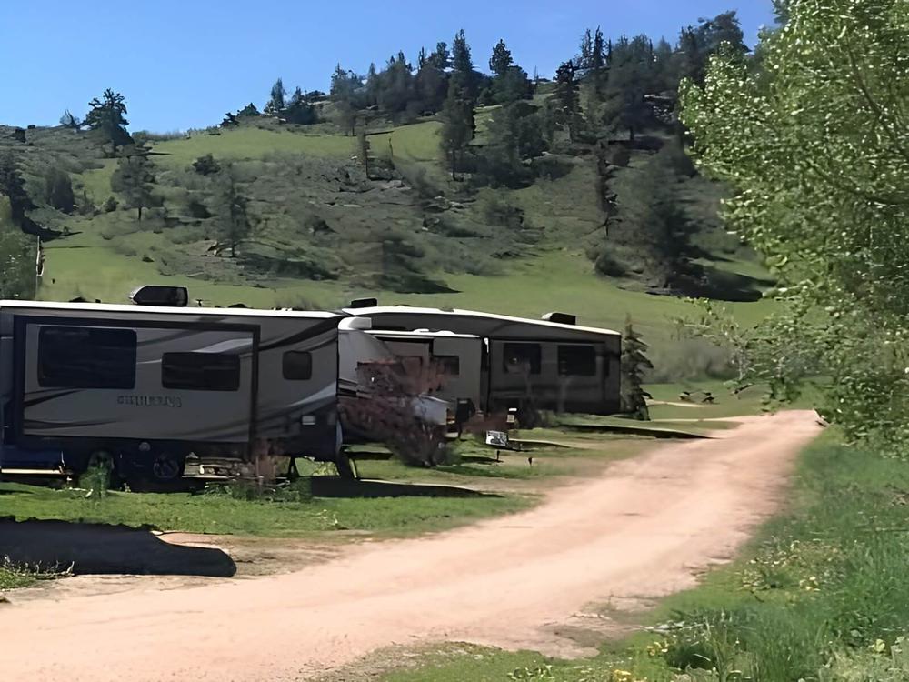 RVs parked near a dirt road