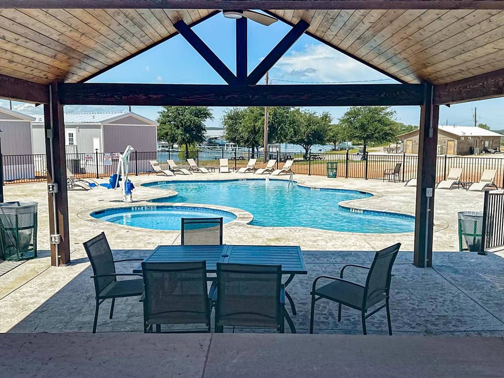 A view of the pool from a covered seating area