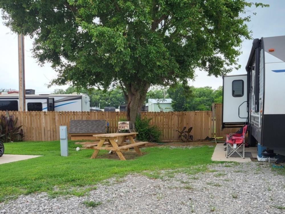 Picnic Table on grass near gravel site at Southern Plains RV Park